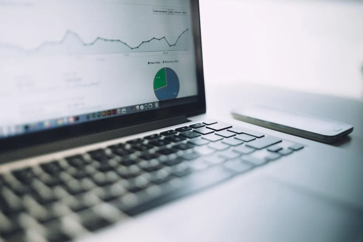 Laptop showing analytics charts on a desk, representing AEO and SEO reporting