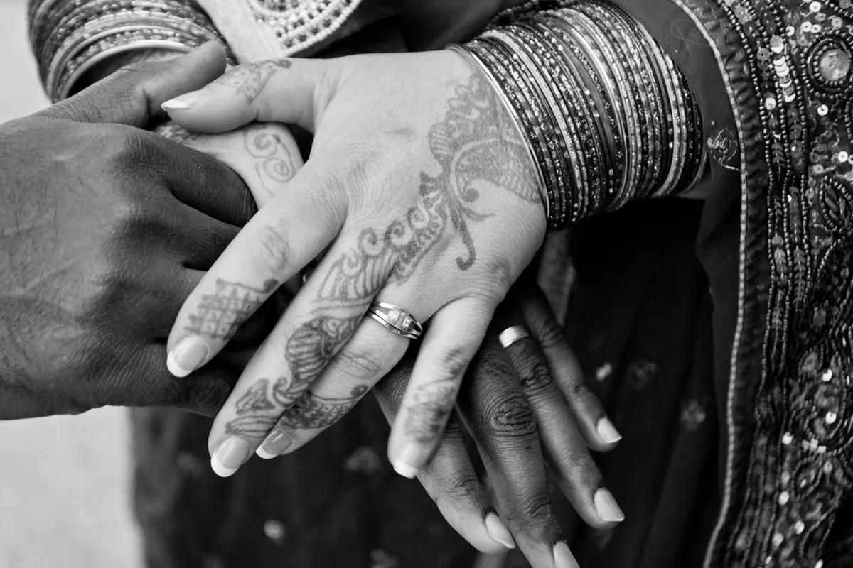 Bride and groom's henna-decorated hands joined at an Indian wedding, representing matrimony platforms built in Coimbatore