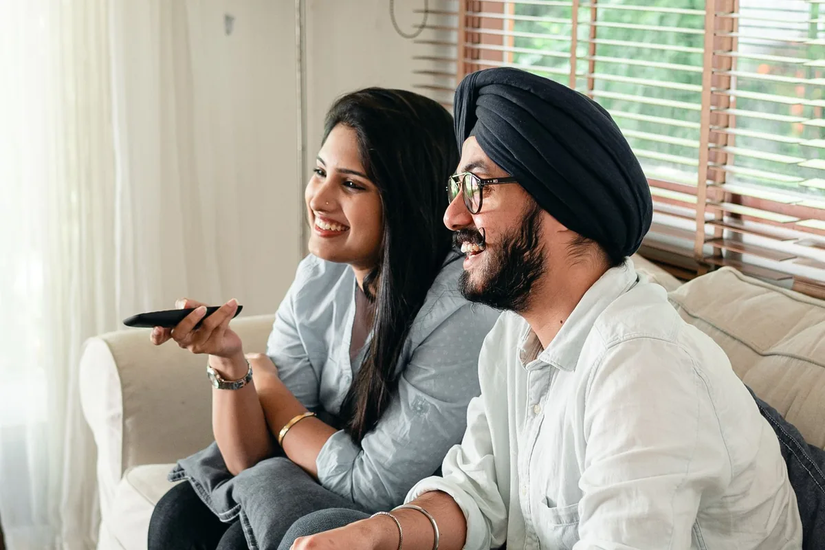 Couple watching a film on a television at home