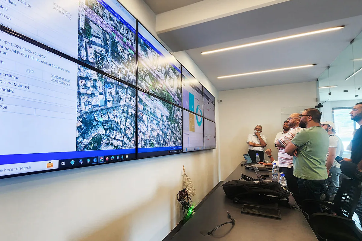 Control room with large data dashboards on screens