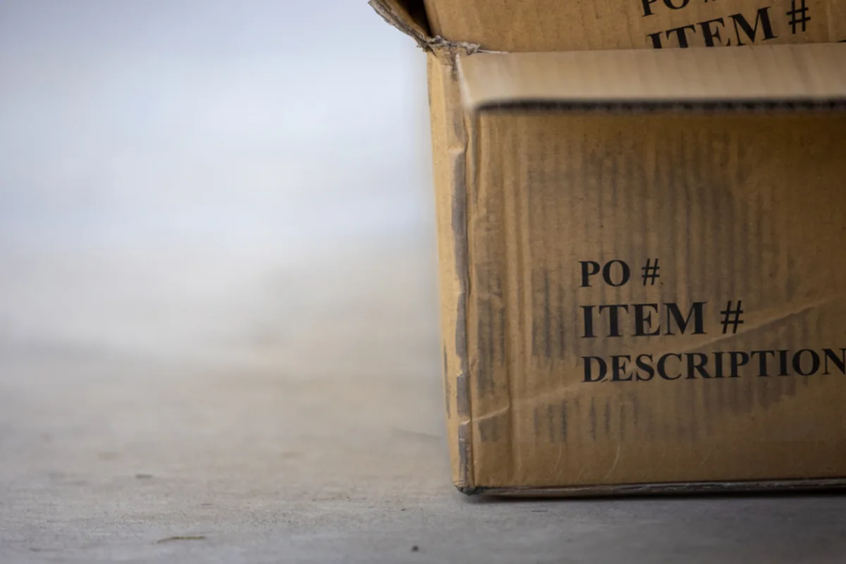 Cardboard shipping box with a packing label, representing online stores built for UK brands